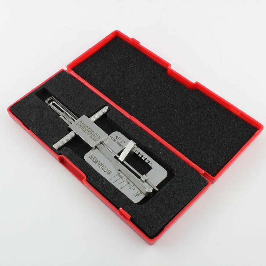 Metal APECS Lock Picking tool in case with engraved text on a white background