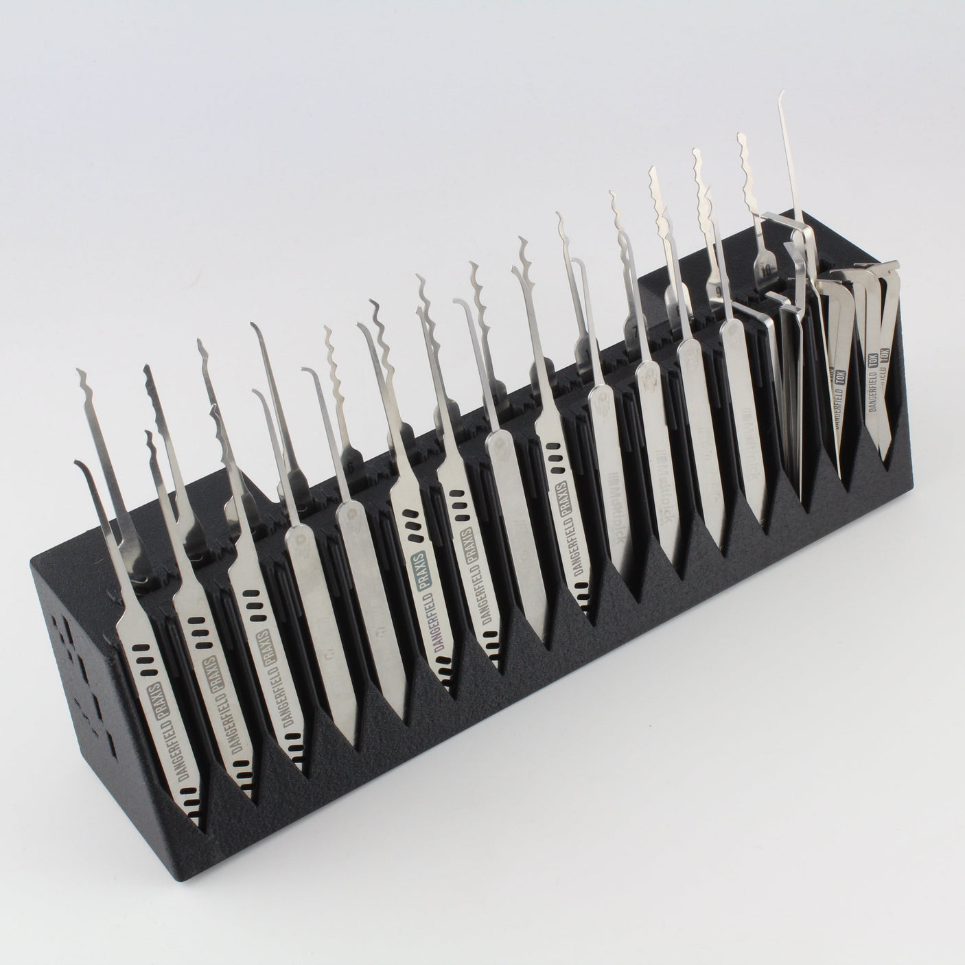 Set of lockpicks in a black holder on a white background