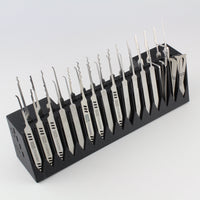 Set of lockpicks in a black holder on a white background