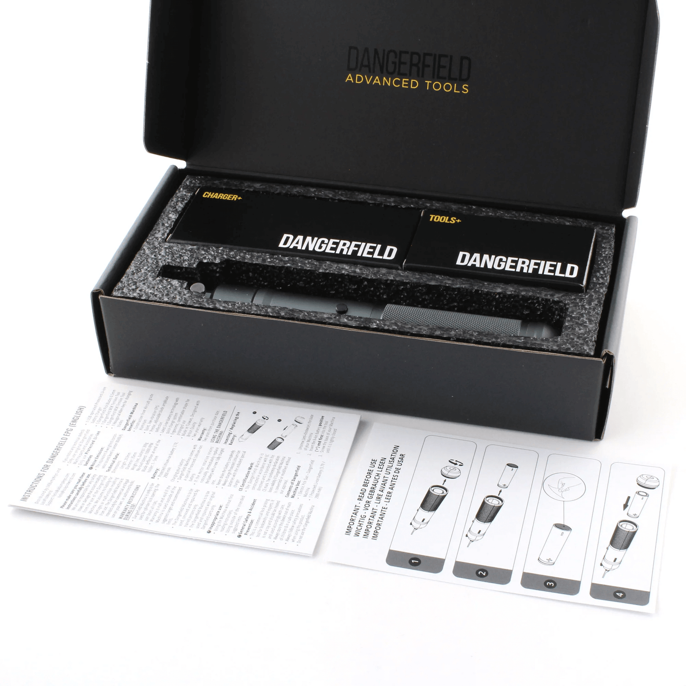 Open black box containing Dangerfield Machina, tools, with manual on a white background