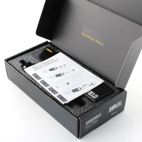 Open box containing a Machina EPG with a manual, on a white background