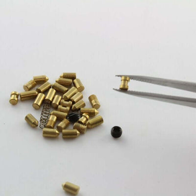 Tweezers holding spool security pin for lock picking practice